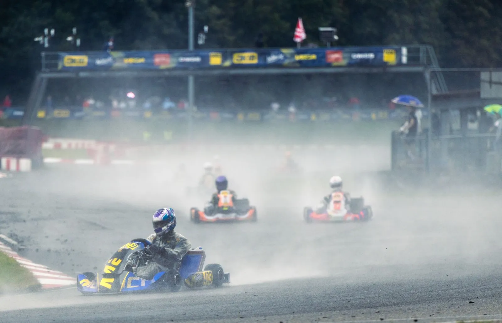 Mach1 Rennkart mit aufgewirbeltem Wasser auf der nassen Strecke in Ampfing